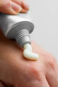 skin care cream from a tube, getting applied to a hand